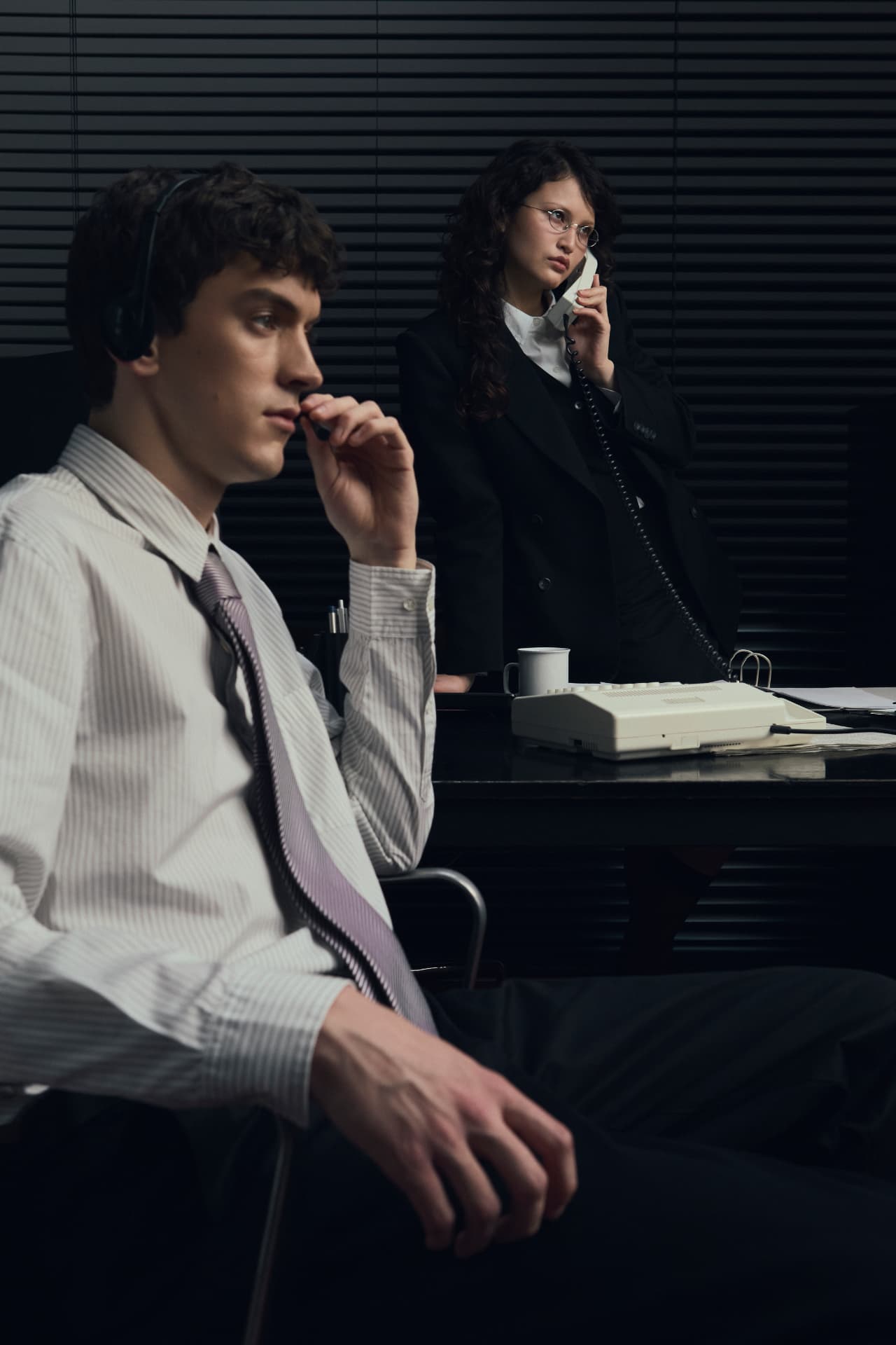 Two concierges working the phones at the desk